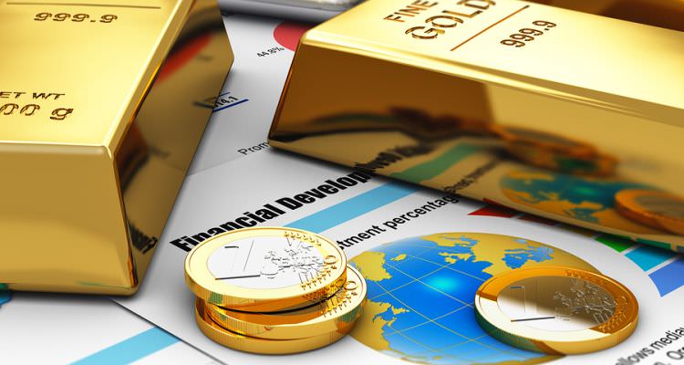 Gold ingots and coins on financial reports